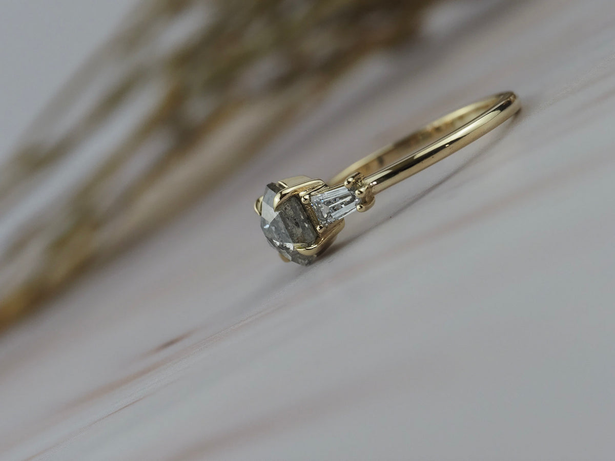Close-up side profile of the Esme hexagon shaped salt and pepper diamond engagement ring with tapered baguette diamonds.