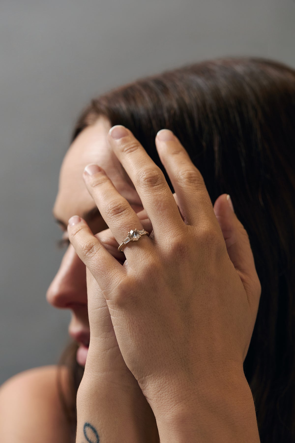 Back profile of the Esme hexagon-shaped salt and diamond engagement ring showing the gold setting and tapped baguette diamonds.