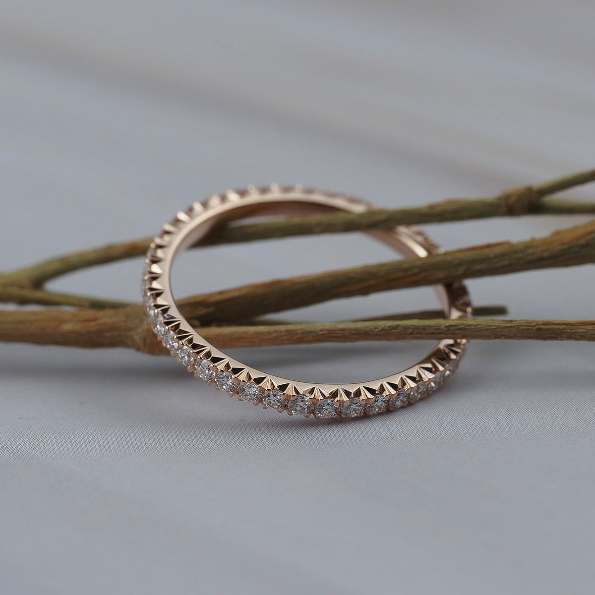 Close-up of diamonds in a classic French pave eternity band, showing the detailed diamond setting.