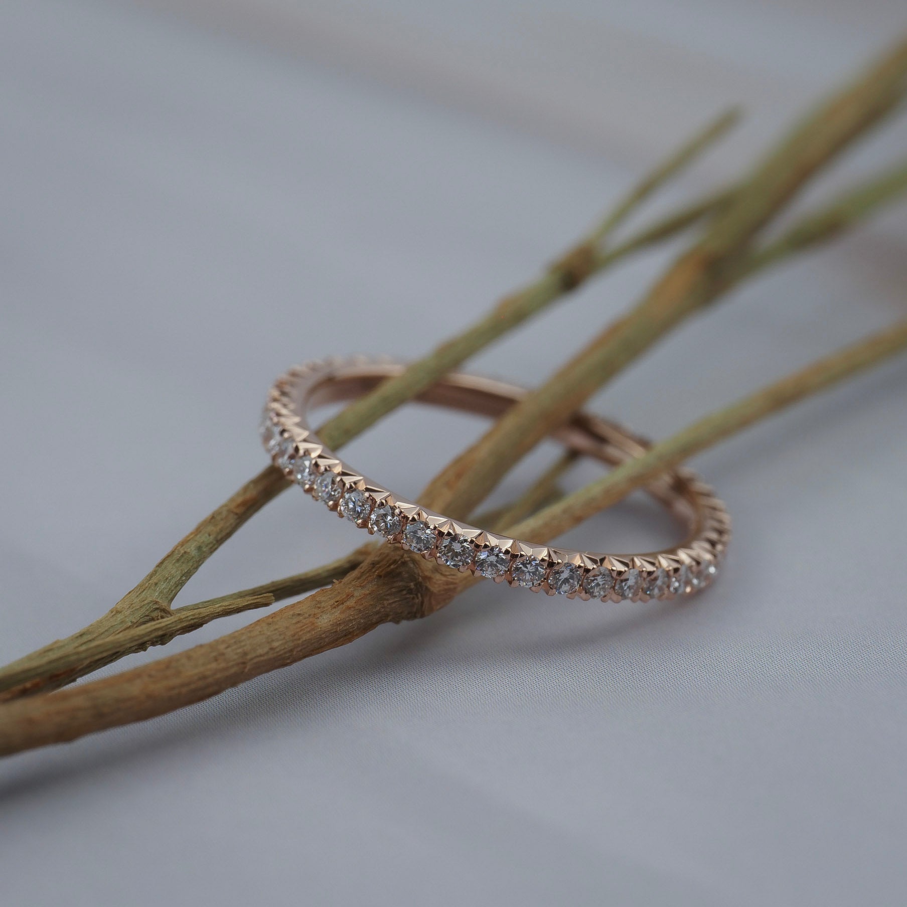 Classic French pave eternity band featuring Canadian diamonds set closely around a Fairmined gold band.