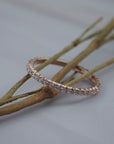 Classic French pave eternity band featuring Canadian diamonds set closely around a Fairmined gold band.