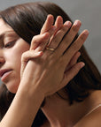 Fairmined yellow gold band with hand-engraved poppy flowers on model's hand.