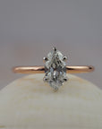 Lena six-claw solitaire engagement ring featuring a moral shaped antique cut Old European diamond in two-tone platinum and rose gold setting.