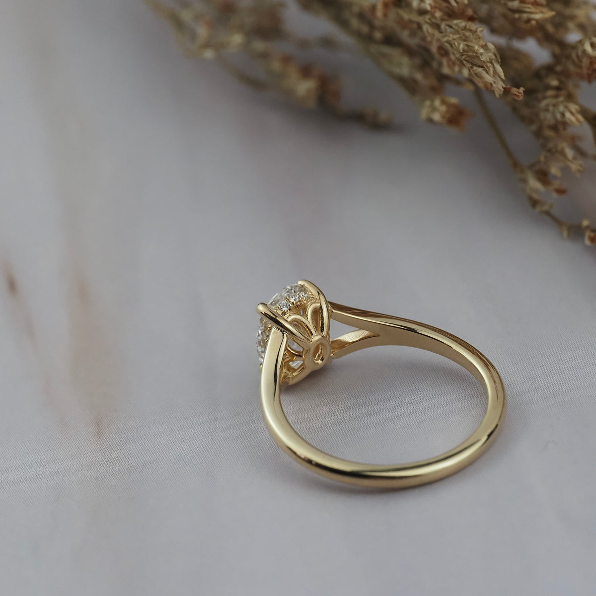 Close-up of the back of the Love Knot diamond solitaire setting showing the hidden halo and spot shank details. 
