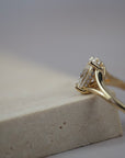 Close-up side view of the Love Knot diamond solitaire engagement ring showing the hidden halo and split shank setting.