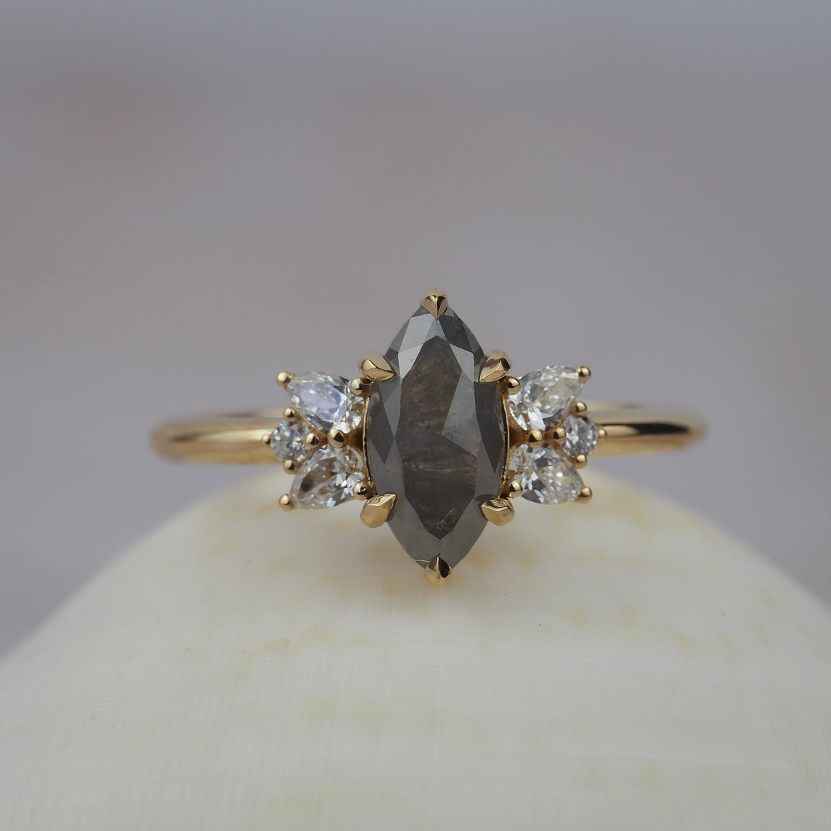 Meghan salt and pepper marquise-shaped rose cut cluster engagement ring featuring a distinctive diamond cluster in a gold setting.