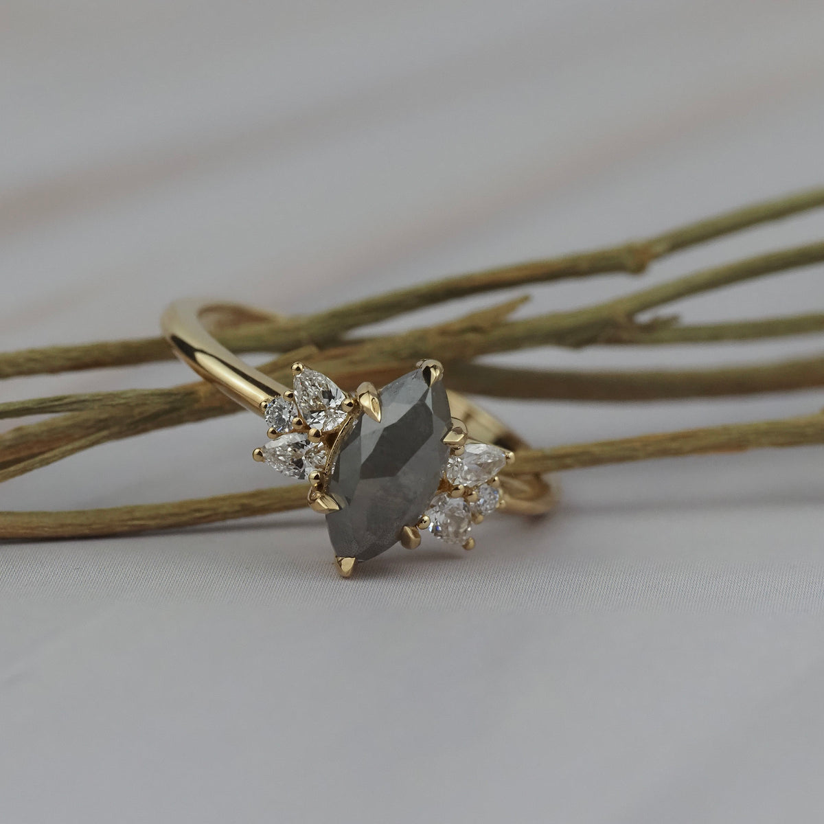 Close-up detail of the Meghan salt and pepper marquise shaped rose cut cluster engagement ring showing its handcrafted gold setting.