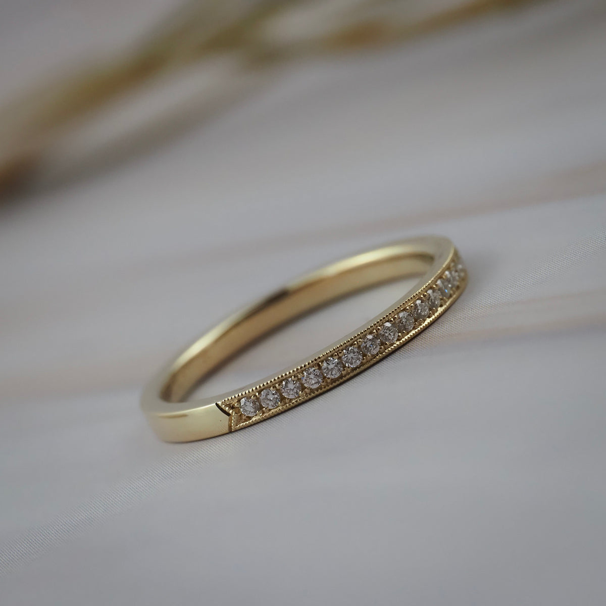 Handcrafted milgrain wedding band in Fairmined yellow gold featuring Canadian diamonds.