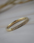 Handcrafted milgrain wedding band in Fairmined yellow gold featuring Canadian diamonds.