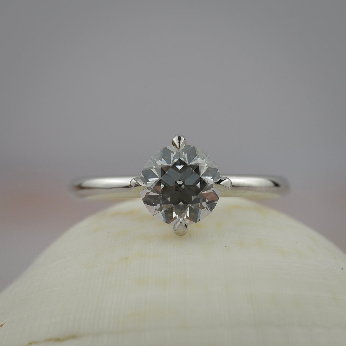 Myra compass platinum claw solitaire engagement ring featuring an Old European cut diamond.