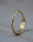 Back view of the organic textured leaf wedding band showing the hand carved gold setting and lab-grown diamonds.