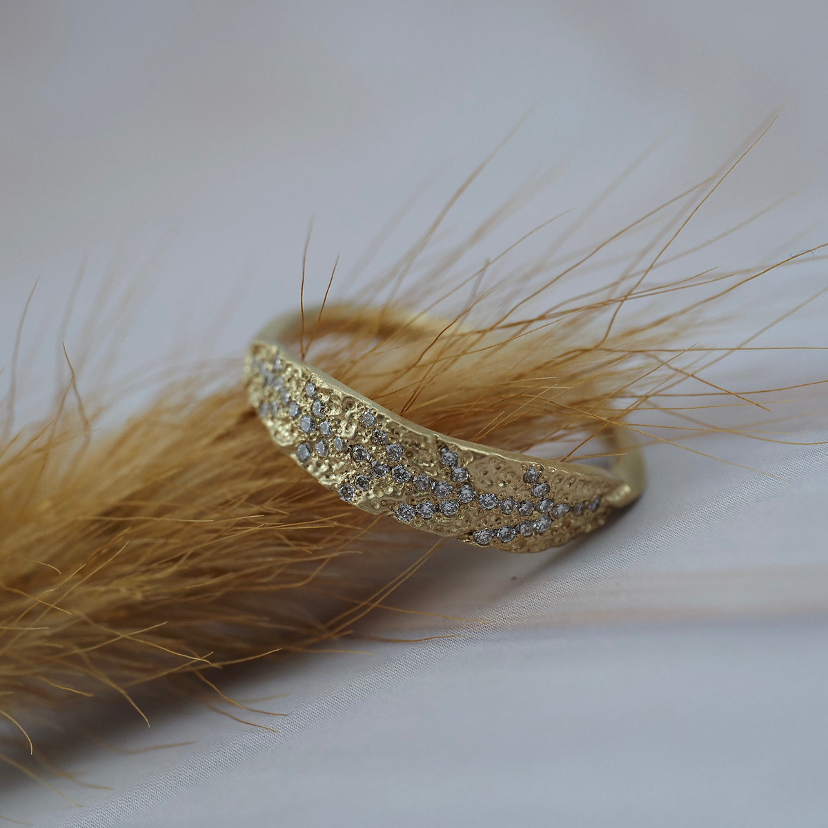 Organic textured leaf wedding ring crafted in Fairmined gold with Canadian diamonds.