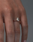 Close-up video of the lena six-claw solitaire engagement ring worn on a woman finger, featuring a moval shaped antique cut Old European diamond in a two-tone platinum and rose gold setting. 