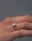 Close-up video of the Love Knot split shank diamond solitaire engagement ring with hidden halo worn on a woman's hand.