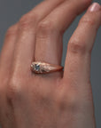 Close-up video of the Mrs. Erykah hand engraved floral bombe engagement ring in Fairmined gold with a Canadian diamond horns on a woman's hand.