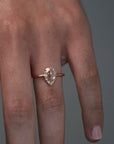 Close-up video of the Avery pear shaped rose cut diamond solitaire engagement ring worn n a woman's finger.