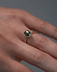 Close-up video of a woman wearing the Elanor salt and pepper oval diamond six-claw solitaire, showing the Art Deco woven setting and milgrain edge. 