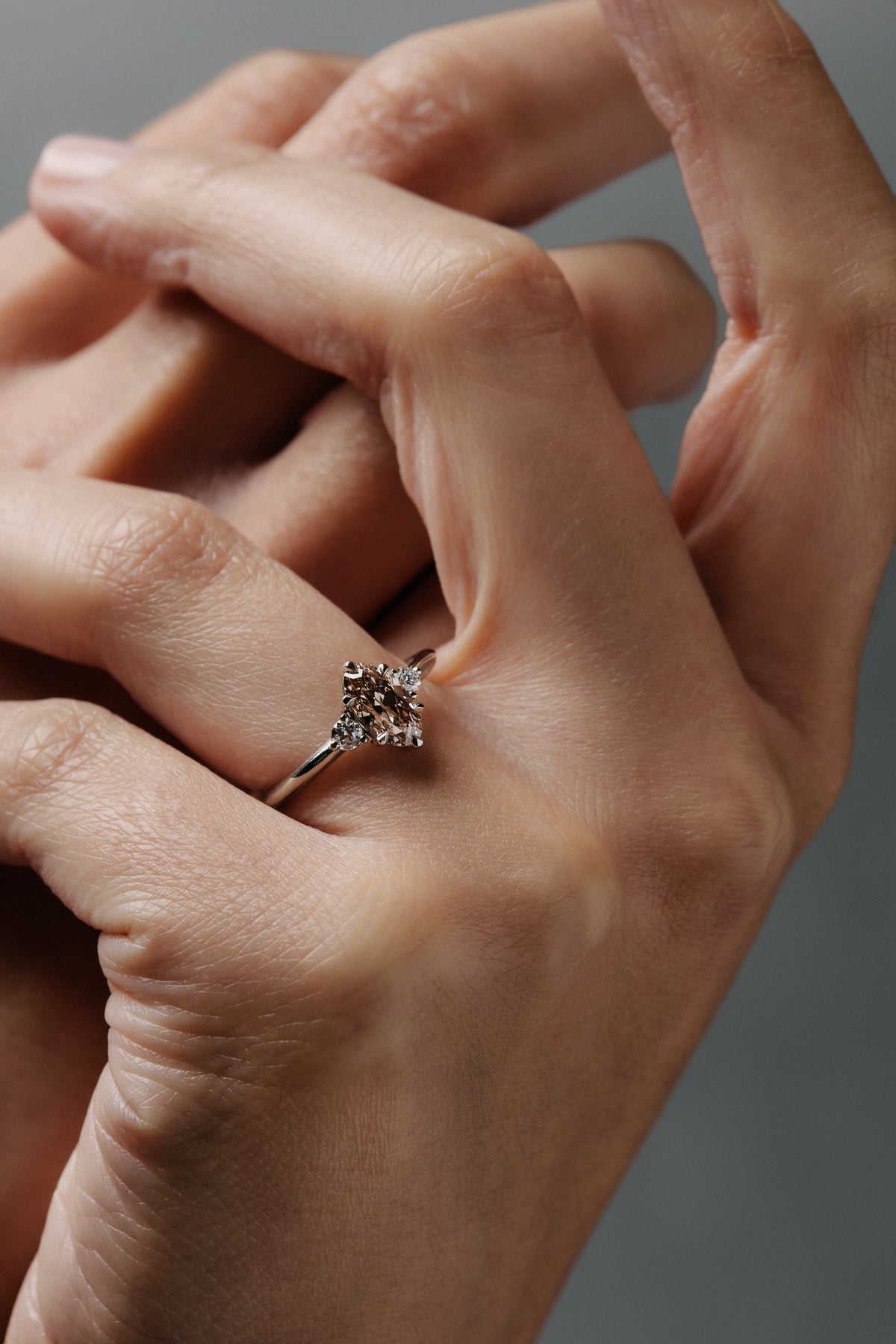 Rebecca three stone engagement  ring featuring a champagne toned move cut diamond accented by white full cut diamonds.