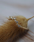 Close-up of the Snowflake diamond wedding band showing its delicate snowflake-inspired gold design and Canadian diamonds.