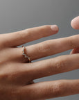 Close-up of a woman wearing the Snowflake curved diamond wedding band on her ring finger. 