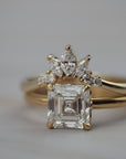 Trillium curved gold wedding band paired with an asscher-cut diamond engagement ring.
