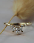 Trillium curved gold wedding band featuring marquise and round diamonds n a delicate floral inspired design.