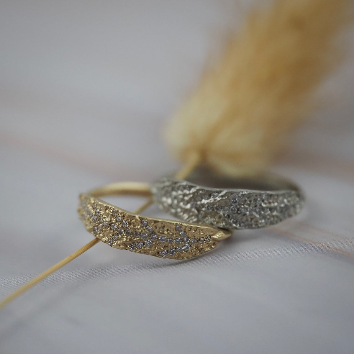 White and yellow gold pave leaf rings featuring delicate diamond details in a botanical-inspired design.
