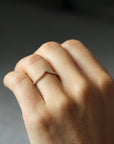 Close up of model hand wearing the Chevron Mia womens wedding band by Fluid Jewellery in yellow gold