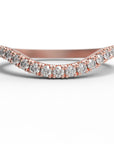 Close up of the curved Caia womens wedding band by Fluid Jewellery in rose gold