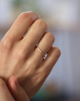 Close up of model hand wearing the Pave Jane womens wedding band by Fluid Jewellery in rose gold